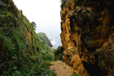 Rock formation amidst sea against sky