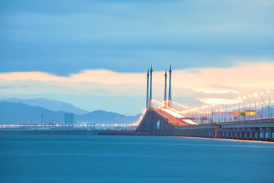 View of bay bridge against cloudy sky