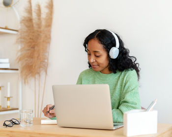 Young woman using laptop at home