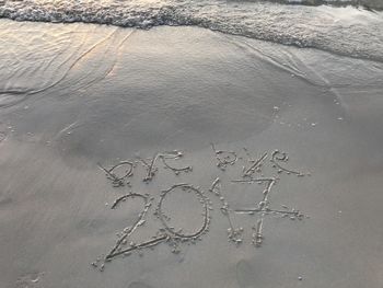 High angle view of text on beach