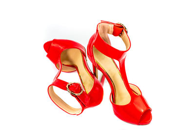 Close-up of red shoes against white background