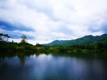 Scenic view of lake and mountains against sky