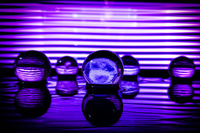 Close-up of illuminated glasses on table