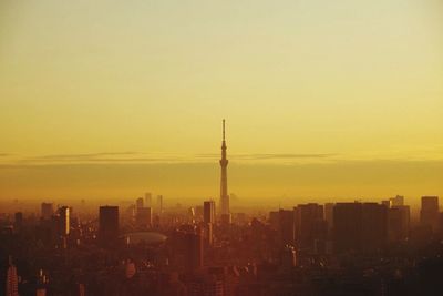 Tokyo sky tree with cityscape against sky during sunset