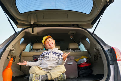 Portrait of smiling man sitting in car