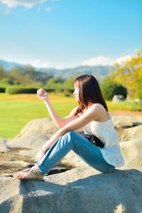 Young woman sitting on field