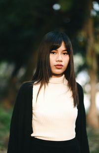 Portrait of young woman standing outdoors