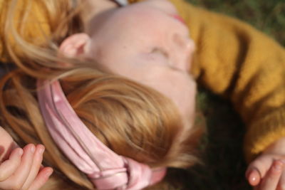 Close-up portrait of woman lying down