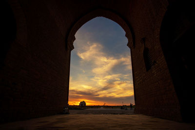 Low angle view of buildings against sky during sunset