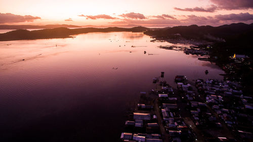 High angle view of city by sea against sky