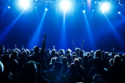 Crowd enjoying at music concert at night