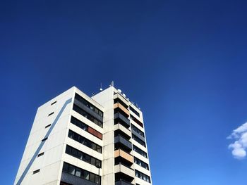 Low angle view of modern building against clear blue sky