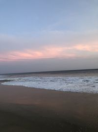 Scenic view of beach against sky during sunset