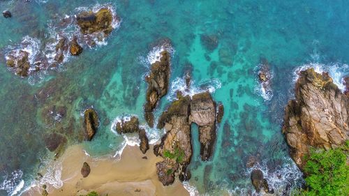 Directly above view of rock formations on shore