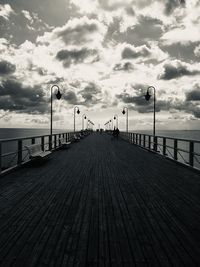 Surface level of pier on sea against sky
