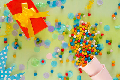 High angle view of multi colored toys on paper