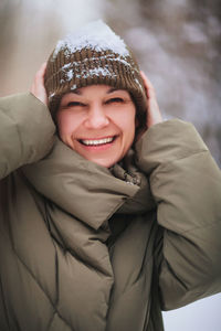 Portrait of smiling young woman during winter