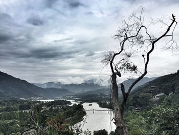 Scenic view of mountains against cloudy sky