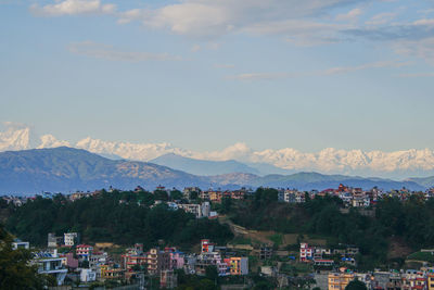 High angle view of townscape and mountains against sky