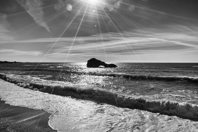 Scenic view of sea against sky on sunny day