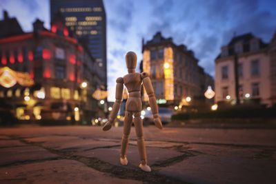 Rear view of man standing on street at night