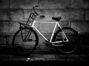 Bicycle parked against wall