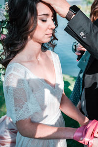 Young woman using mobile phone while standing on camera