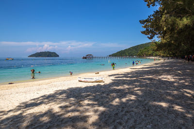 Scenic view of beach against blue sky