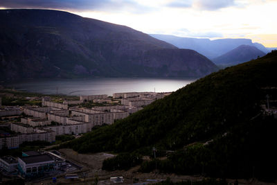 High angle view of townscape and mountains against sky