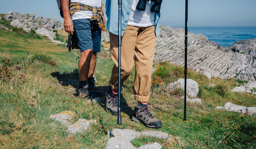 Unrecognizable couple practicing trekking together outdoors