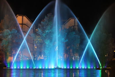 Illuminated ferris wheel at night