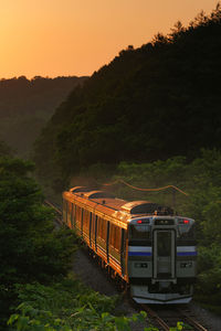 Kiha 201 rapid train niseko liner shining in the setting sun