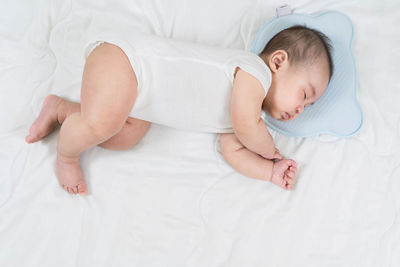 High angle view of baby sleeping on bed