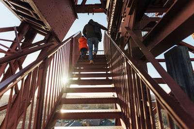 Low angle view of man walking on staircase