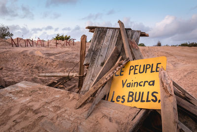 Information sign on land against sky