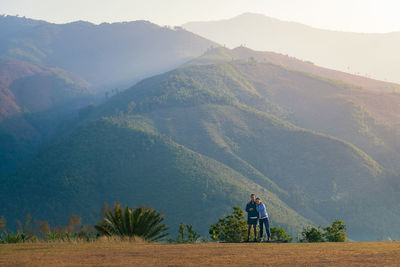 Rear view of man walking on mountain
