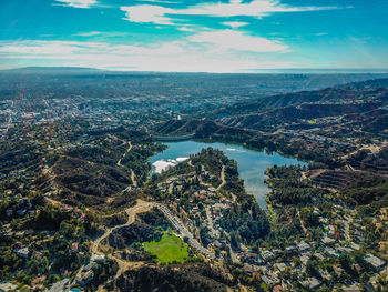 High angle view of bay and buildings against sky