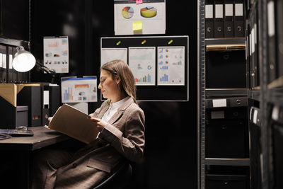 Midsection of woman using laptop