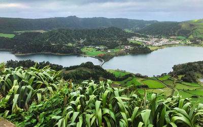 Scenic view of lake and mountains against sky