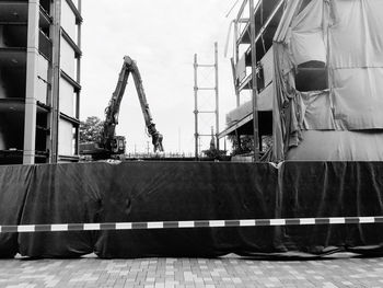 Construction site by building against sky