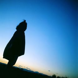 Silhouette of sculpture against clear blue sky