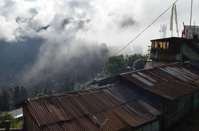 Houses on mountain against sky