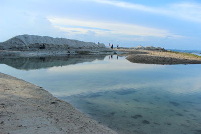 Scenic view of sea against cloudy sky