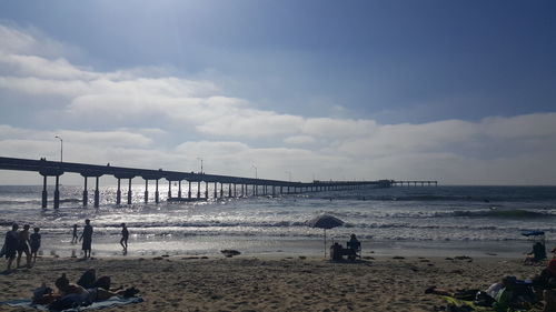 People on beach against sky