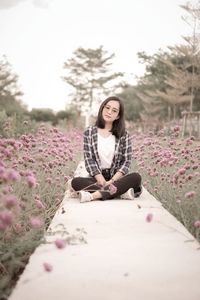 Young woman sitting on field