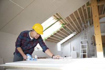 Side view of man working in workshop