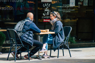 People sitting on chair at cafe