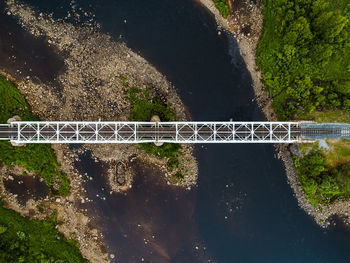 Aerial view of railroad bridge over river