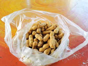 High angle view of coffee beans in container on table