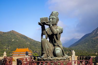 Asian temple statue in hong kong against sky